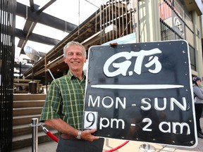 Steve Cordes, executive director of Youth Opportunities Unlimited, shows off some of the memorabilia on the block at Friday?s fundraising auction for YOU?s new, $15-million residence at Richmond and York streets. (MIKE HENSEN, The London Free Press)