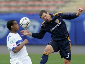TFC coach Greg Vanney (right) goes for a header during his playing days with L.A. Galaxy. (POSTMEDIA NETWORK FILES)