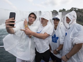 (left to right) Rinat Valiev, Zach Hyman, Connor Carrick and William Nylander take a selfie at the bottom of Niagara Falls as a group of Toronto Maple Leafs enjoy a ride on the Hornblower tour boat on Friday, Sept. 15, 2017. (Craig Robertson/Toronto Sun)