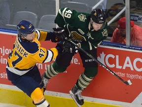 Erie defence man Owen Hendrick takes London forward Max Jones into the boards during a pre-season game played at Budweiser Gardens in London, Ontario on Friday September 15, 2017 MORRIS LAMONT/THE LONDON FREE PRESS /POSTMEDIA NETWORK