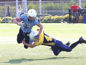 Max MacGilivray, left, of the St. Benedict Bears, is tackled by Nathaniel Goupil, of College Notre-Dame, during high school football action at James Jerome Sports Complex in Sudbury, Ont. on Friday September 15, 2017. John Lappa/Sudbury Star/Postmedia Network