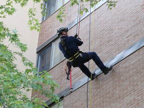 Greater Sudbury firefighters take part in a height-based training exercise at Rockview Towers in Sudbury on Friday. A total of 18 firefighters participated in the training provided by Spartan Rescue. The training was provided so the participants will eventually be able to offer in-house training to other Greater Sudbury firefighters.