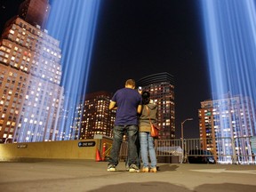 People gather on a rooftop as the 'Tribute in Light' illuminates the night sky, on September 10, 2017 in New York City, on the eve of the anniversary of the September 11, 2001 terror attacks. Commemorations are being held on the 16th anniversary of the 9/11 terror attacks, with President Donald Trump expected to speak at a ceremony for the 184 people killed at the Pentagon in Washington, D.C. (KENA BETANCUR/AFP/Getty Images)