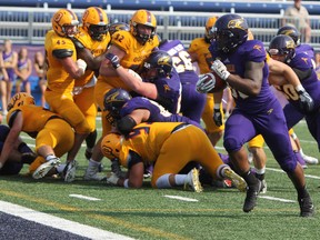 Golden Hawks Osayi Iginuan runs into the Gaels' end zone unchallenged for a touchdown during the first half of Ontario University Athletics action at Richardson Stadium in Kingston, Ont. on Saturday September 16, 2017. Wilfrid Laurier defeated Queen's University 40-17. Steph Crosier/Kingston Whig-Standard/Postmedia Network