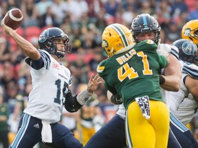 Toronto Argonauts quarterback Ricky Ray, left, looks to make a pass during second half CFL football action against the Edmonton Eskimos in Toronto on Saturday, September 16, 2017.