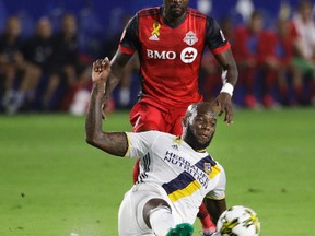 Los Angeles Galaxy's Michael Ciani (bottom) kicks the ball away from Toronto FC's Tosaint Ricketts during the first half of an MLS soccer match Saturday, Sept. 16, 2017, in Carson, Calif. (JAE C. HONG/AP)