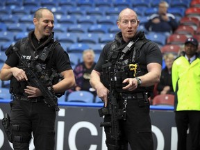 Armed police provide security before the English Premier League soccer match at the John Smith's Stadium in Huddersfield, England, on Saturday, Sept. 16, 2017. (Mike Egerton/PA via AP)