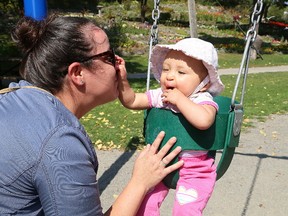 Michelle Forgette pushes her cousin, Dianna Seth, nine months, on a swing at Bell Park in Sudbury, Ont. on Saturday September 16, 2017. John Lappa/Sudbury Star/Postmedia Network