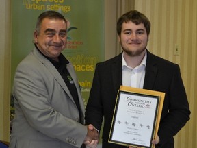 Kevin Moorhouse accepts the Five Bloom Rating from Chris Ziemski, a judge with Communities in Bloom.
