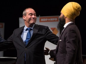 Guy Caron, left, and Jagmeet Singh come together on stage after the final federal NDP leadership debate in Vancouver, B.C., on Sunday Sept. 10, 2017.  THE CANADIAN PRESS/Darryl Dyck