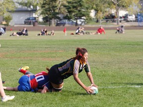 Division II Sirens rugby player Rayne Rigler tries to retain the ball after a crushing tackle from St. Albert's Kendall Dewitt. The Sirens battled to a semi-final win 51-17 on Saturday September 16, 2017 in Grande Prairie, Alta. 
Jordan Parker/Grande Prairie Daily Herald-Tribune/Postmedia Network