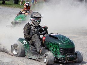 Competitors take part in lawn tractor racing at the Kingston Fall Fair at the Memorial Centre on Saturday. (Steph Crosier/The Whig-Standard)