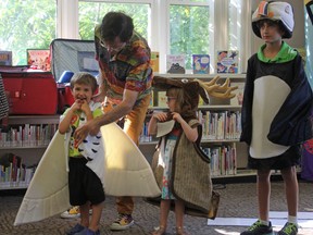 Family entertainer Peter Puffin (Peter Lenton), left, performs at the Kingscourt library's Last Day of Celebrations on Saturday. (Steph Crosier/The Whig-Standard)
