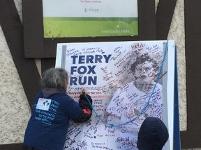 Nancy Chartrand signs the Terry Fox Run poster near the Lyric Theatre stage following the 37th annual Terry Fox Run at Assiniboine Park in Winnipeg on Sunday, Sept. 17, 2017. GLEN DAWKINS/Winnipeg Sun/Postmedia Network