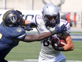 Western Mustangs receiver Malik Bessehieur, right, breaks away from Windsor Lancers Lekan Idowu in OUA action from University of Windsor Alumni Field September 16, 2017.  (NICK BRANCACCIO/Windsor Star)