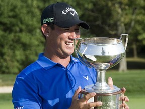 Rico Hoey enjoys a moment with his trophy after winning the Freedom 55 Financial Championship at Highland Country Club in London on Sunday. (Derek Ruttan/The London Free Press)