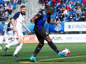 FC Edmonton midfielder Sainey Nyassi, right, takes a shot and goes on to score, with Indy Eleven defender Colin Falvey looking on in North American Soccer League play at Clarke Stadium in Edmonton on Sunday, Sept. 17, 2017. (Tony Lewis / FC Edmonton)