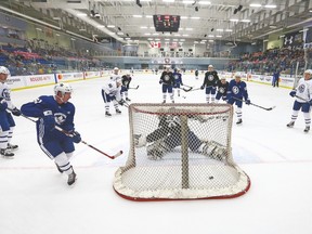 Adam Brooks tucks the puck behind goalie Ian Scott during yesterday’s final drills in Niagara Falls. Both Brooks and Scott were among the first wave of cuts. (Dave Abel, Toronto Sun)