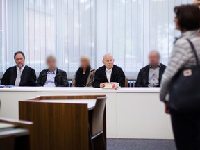 Three defendants sit next to their lawyers, Gerd Kueppers (left) and Manfred Gregorius (fourth from left) as they wait for the start of their trial in Essen on September 18, 2017. (MARCEL KUSCH/Getty Images)