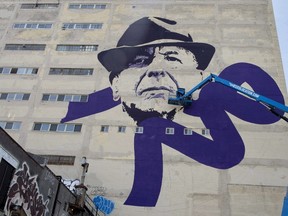 Montreal artist Kevin Ledo works on his nine-story high-portrait of the late Leonard Cohen, in Montreal on Thursday, June 15, 2017. A memorial tribute concert for Leonard Cohen will be held in Montreal on Nov. 6. THE CANADIAN PRESS/Paul Chiasson