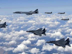 In this photo provided by South Korea Defense Ministry, U.S. Air Force B-1B bombers, F-35B stealth fighter jets and South Korean F-15K fighter jets fly over the Korean Peninsula during joint drills on Monday, Sept. 18, 2017. (South Korea Defense Ministry via AP)