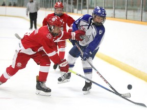 Gabriel Zimbranoof the Soo Greyhounds battles for the puck with Henri Lefebvre of the Sudbury Wolves during major peewee action at the NOHL AAA showcase weekend at the Gerry McCrory Countryside Sports Complex in Sudbury, Ont. on Sunday September 17, 2017. Gino Donato/Sudbury Star/Postmedia Network