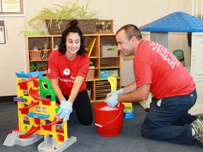 Farm Credit volunteers Hilary Pincombe and Ryan Clubb scrub down toys at the St. Clair Child and Youth Services Family Drop-In Centre as part of the United Way's Day of Caring on Sept. 12.
CARL HNATYSHYN/SARNIA THIS WEEK