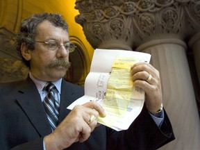 New Hall of Famer Mark Bonokoski, in this file photo from May 17, 2006, examines the ticket for parking in a No Standing zone that he fought successfully in an Old City Hall courtroom. (Postmedia Network file photo)