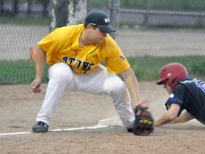 Derek Elliott of the Mitchell Jr. Mets dives safely into third base ahead of the tag from Sebringville’s Brett Nymeyer. ANDY BADER/MITCHELL ADVOCATE