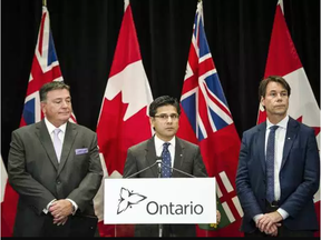 Ontario Attorney General Yasir Naqvi, centre, Minister of Finance Charles Sousa, left, and Minister of Health Eric Hoskins speak during a press conference where they detailed Ontario’s solution for recreational marijuana sales, in Toronto on Friday, September 8, 2017. THE CANADIAN PRESS/Christopher Katsarov