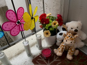 Candles and stuff animals of a makeshift memorial sit outside an apartment Thursday, Sept. 14, 2017, where three children were killed, in West Sacramento, Calif. The children are killed around 9 p.m. Wednesday, and their father Robert Hodges, 33, has been arrested in the deaths that followed a domestic violence altercation with his wife. (AP Photo/Rich Pedroncelli)
