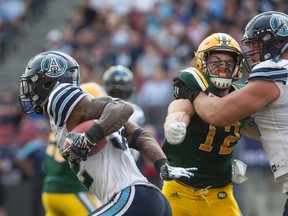 Argonauts running back James Wilder Jr. (left) finds space in the Eskimos defence on Saturday. (Chris Young/The Canadian Press)