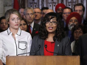 Liberal MP Iqra Khalid makes an announcement about an anti-Islamophobia motion on Parliament Hill while Minister of Canadian Heritage Melanie Joly looks on in Ottawa on Wednesday, February 15, 2017. (THE CANADIAN PRESS/ Patrick Doyle)