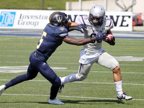 Western Mustangs receiver Malik Bessehieur, right, uses a stiff arm against Windsor Lancers Lekan Idowu in OUA action from University of Windsor Alumni Field September 16, 2017. (NICK BRANCACCIO/Windsor Star)