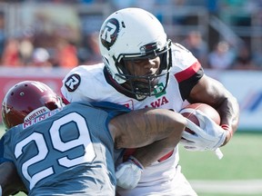 Ottawa Redblacks' William Powell, right, breaks away from a tackle by Montreal Alouettes' Jonathan Mincy during CFL action in Montreal on Sept. 17, 2017. (THE CANADIAN PRESS/Graham Hughes)