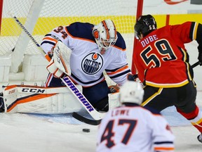 Edmonton Oilers Nick Ellis makes a save on a shot by Dillon Dube of the Calgary Flames during NHL pre-season hockey at the Scotiabank Saddledome in Calgary on Monday, September 18, 2017.