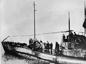 In this undated photo people stand on the deck of a World War I German submarine type UC-97 in an unknown location. (AP Photo, File)