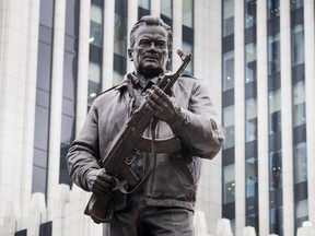 A new monument to Russian firearm designer Mikhail Kalashnikov is unveiled during an official ceremony in Moscow, Russia, Tuesday, Sept. 19, 2017. (AP Photo/Pavel Golovkin)