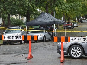 Police have 37 St. closed off to traffic as they investigate the scene where a body was found in this car on 37 St. near 118 Ave. in Edmonton, September 19, 2017. Ed Kaiser/Postmedia