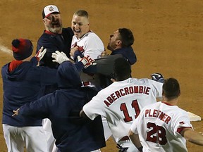 Winnipeg Goldeyes manager Rick Forney (top left) and the rest of the team rush to congratulate David Rohm after he drove in the winning run in the bottom of the 17th inning in Game 4 of the best-of-five American Association championship series against the Wichita Wingnuts in Winnipeg on Mon., Sept. 18, 2017. Kevin King/Winnipeg Sun/Postmedia Network