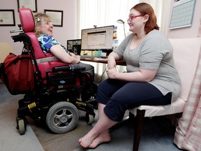 Heidi Janz, left, and Tyler Parker chat in Janz's home on April 28, 2014. Janz had directed a film about people with disabilities caring for others.