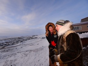 Prime Minister Justin Trudeau and President of the Inuit Tapiriit Kanatami Natan Obed talk as they overlook Iqaluit, Nunavut on Feb. 9, 2017. (Sean Kilpatrick/The Canadian Press)