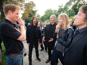 Prince Harry with singer Dave Grohl and drummer Taylor Hawkins of the Foo Fighters attend an Invictus Games Reception at the American Ambassador's Residence, Winfield House on September 9, 2014 in London, England. The International sports event for 'wounded warriors', presented by Jaguar Land Rover, is just days away with limited last-minute tickets available at www.invictusgames.org (Photo by Geoff Pugh - WPA Pool/Getty Images)
