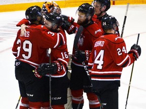 Members of the Owen Sound Attack comfort each other after being eliminated from the Ontario Hockey League's Western Conference final playoff series by the Erie Otters in April 2017. (Denis Langlois, Postmedia Network)