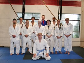 Huron BJJ Head Instructor Shaun Gregory (in front) poses with his students at WorkHorse Strength and Conditioning gym in Clinton before last Wednesday night’s class. Gregory says his students, who range in age and skill level, are “pumped” for November’s tournament after months of not being able to compete at events. Back row (left to right): Jeff Cera, Cody Fischer, Joel Belcourt, Matt Elligson. Front row (left to right): Mike Dale, Mike Morrison, Allison Elligson, Madelynn VanLaar, Victoria Howard, Jenn Fleming.