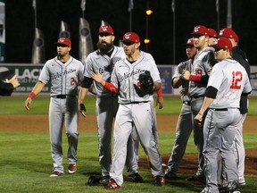 Home plate umpire Joe Stegner (left) breaks up the celebration of the Wichita Wingnuts, who thought they'd won the best-of-five American Association championship series in Game 4 against the Winnipeg Goldeyes in Winnipeg on Mon., Sept. 18, 2017. A balk had been called on the play. Kevin King/Winnipeg Sun/Postmedia Network