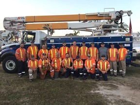 Mike Lepelaars, back left, and Mark Pearson, front left, from Bluewater Power are part of a crew of utility workers from Canada helping restore power in hurricane-damaged Florida. They're currently helping restore electricity in Naples. (Submitted)