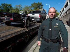 Glen Ehler, director of wildlife enforcement for Enviroment Canada, heads past a seized truck and trailer used in smuggling narwhal tusks, in Dartmouth, N.S. on Wednesday, Oct. 2, 2013. (THE CANADIAN PRESS/Andrew Vaughan)