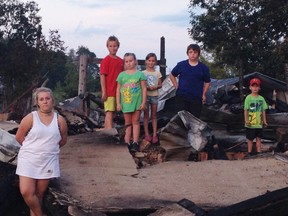 Submitted Photo
Members of the McFaul family stand among the remains of their Marmora home. A pair of local teachers are spearheading a fundraising effort to help the local family rebuild.