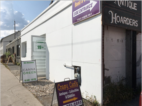 The CannaGreen pot shop and Crazy Car's Antiques are in the same building on Armstrong Street. Thieves broke into Carl's then tore a hole into the interior wall between the two businesses in order to rob the pot shop.  (Jacquie Miller, Postmedia)